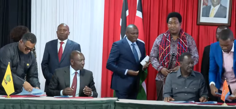 Screengrab image of Ruto and Raila signing an agreement.